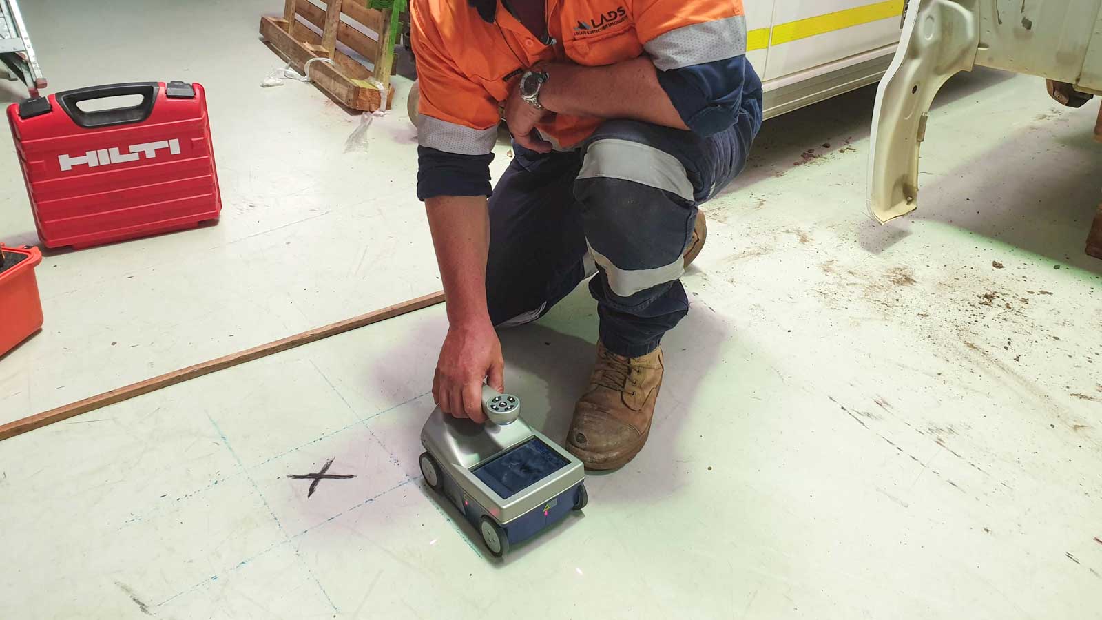 A LADS technician scanning a concrete slab with a GPR concrete scanner